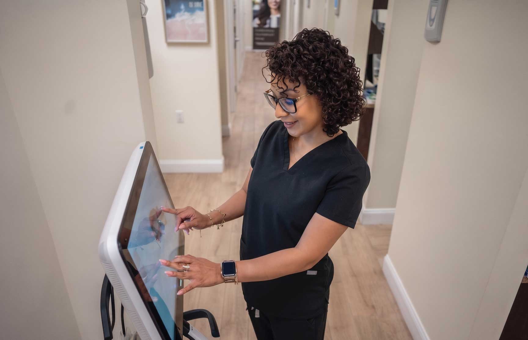 Aesthetic Dental office manager showing a patient an Itero digital scan for a crown