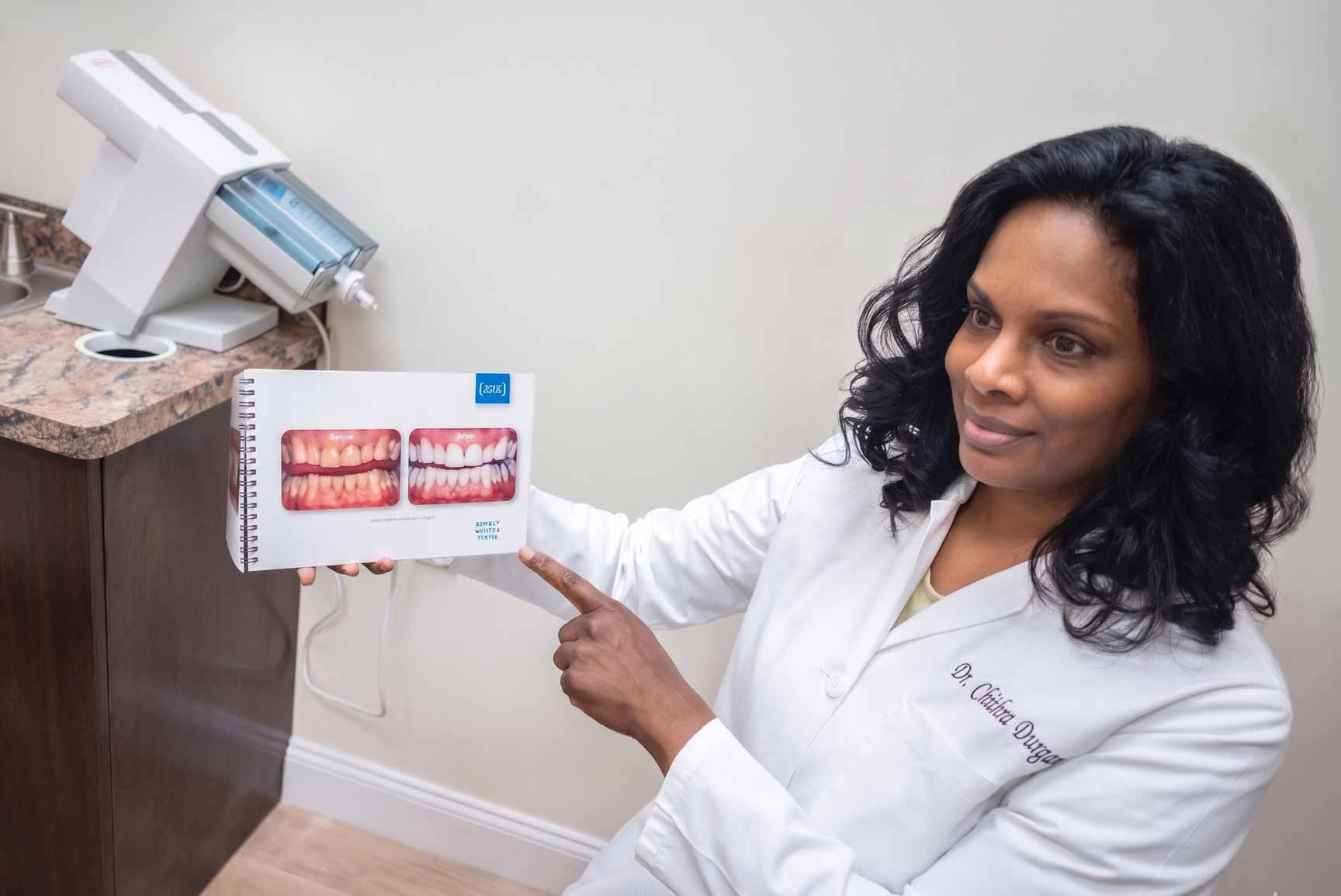 Dr. Chithra Durgam showing a patient before and after photos of KOR whitening