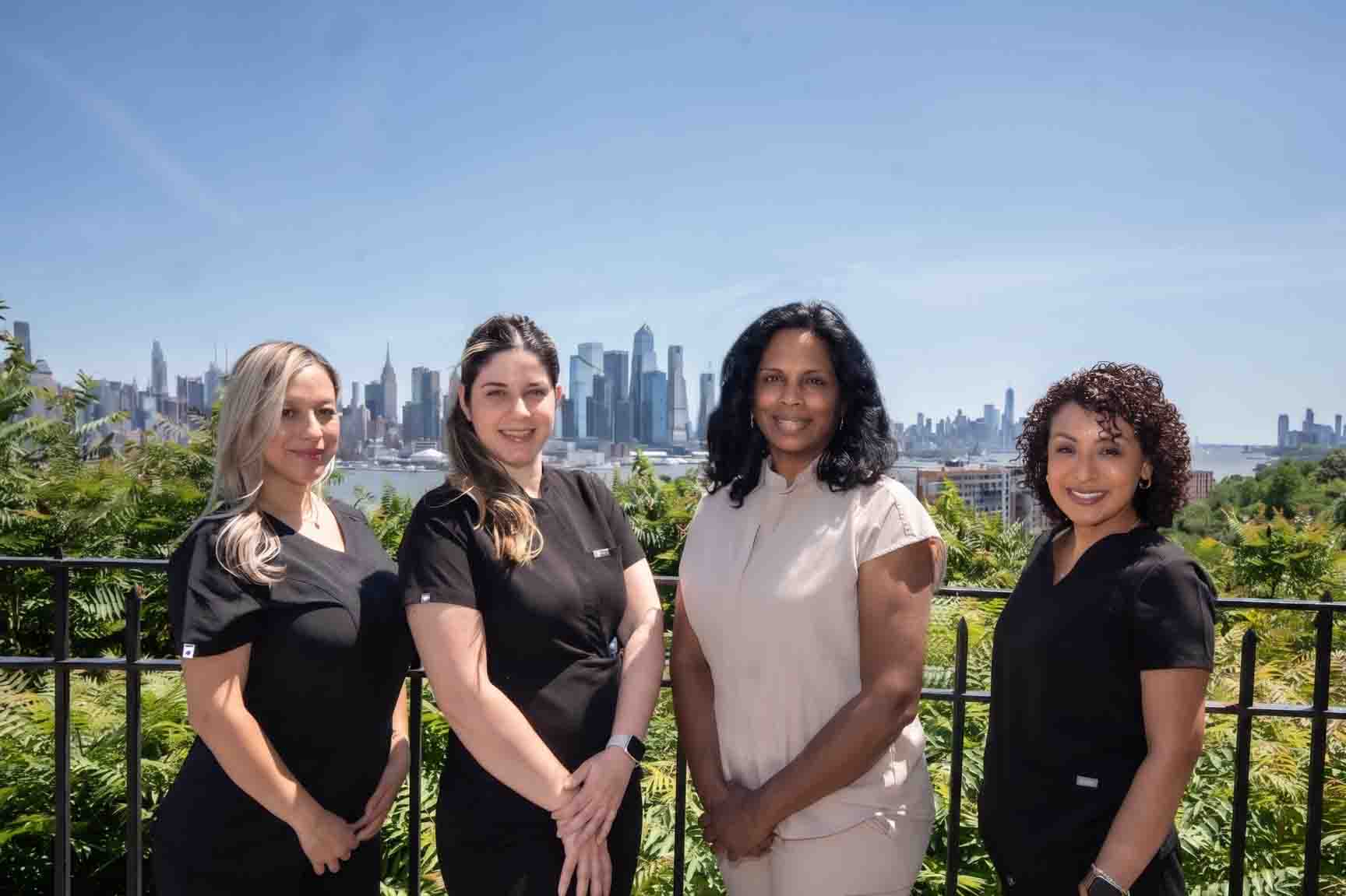 The Aesthetic Dental team posing in front of New York City, New York. Dr. Durgam previously taught at NYU Dental school for two years